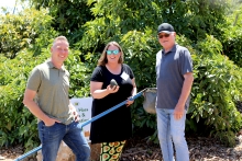 California avocado growers Chris Ambuul and Mike Sanders with reporter Pamela Riemenschneider showing off the avocado she picked.