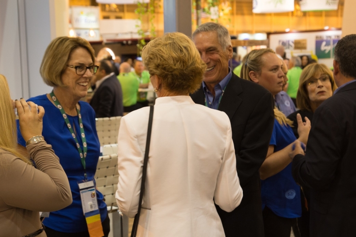 CAC President Tom Bellamore and Vice President Jan DeLyser greet PMA CEO Cathy Burns in the CAC booth.