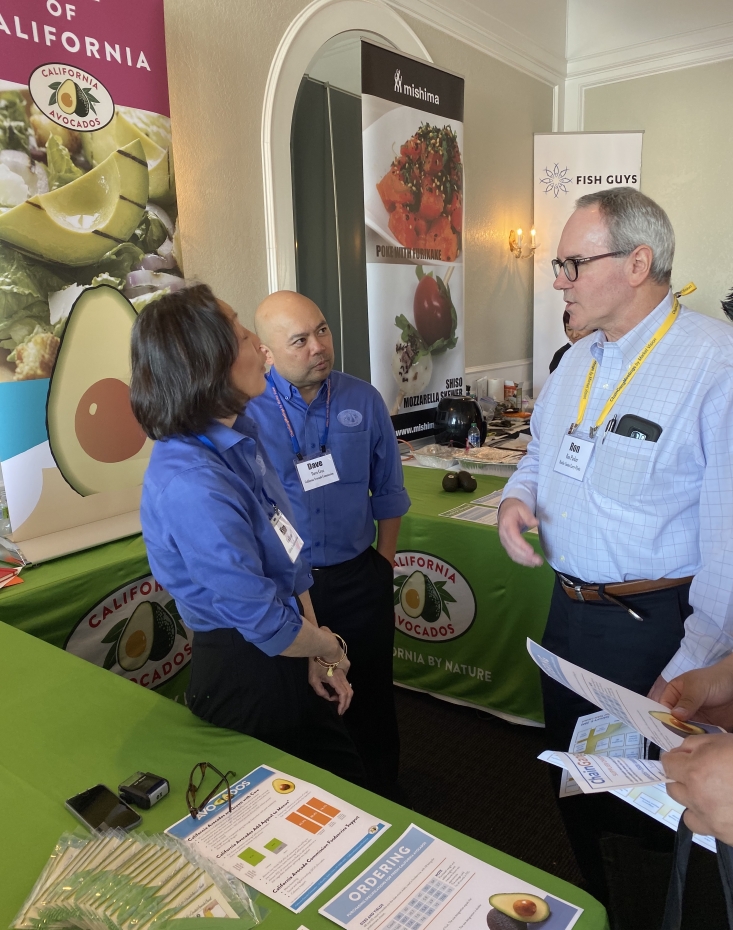 CAC foodservice team member Kim Kurata and Business Development Director Dave Cruz discuss California avocado menu items with Hustler Casino.