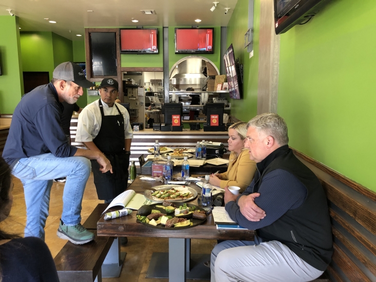 Chef Hernandez discusses the ease of preparing California avocado menu items with the Fresh Brothers Pizza executive team.